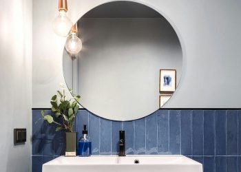 How do you remove stains from a bathroom mirror?