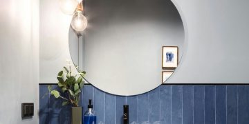 How do you remove stains from a bathroom mirror?